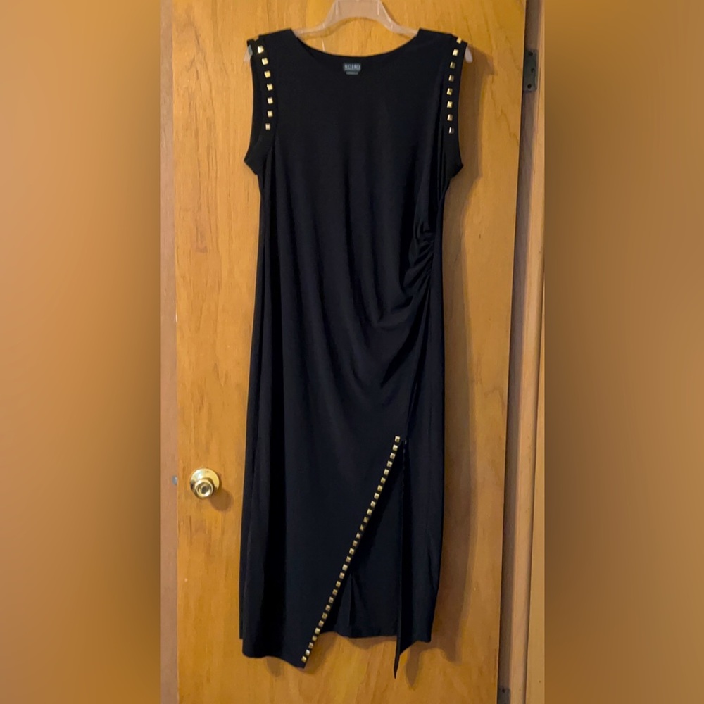 Black fitted maxi dress with diagonal slit at the knee with decorative spots